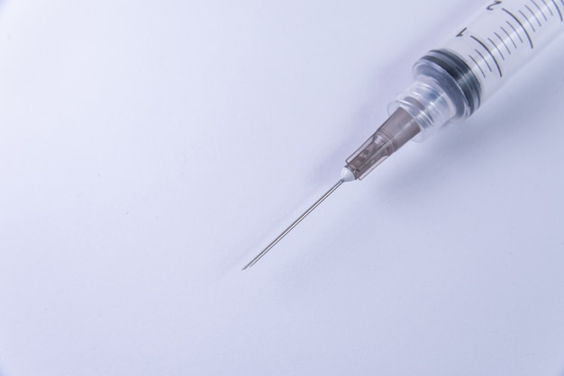 Plastic syringe on the white background