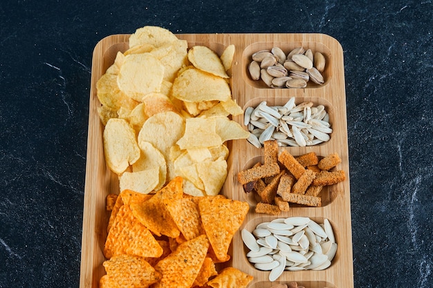 Plate of assorted snacks on a dark ta table