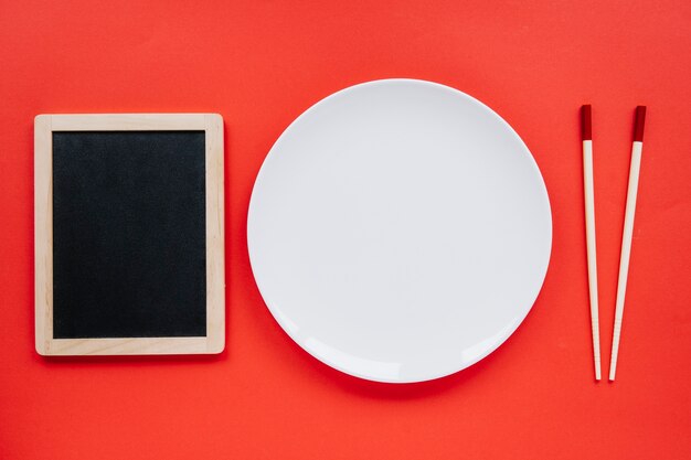 Plate between blackboard and chopsticks