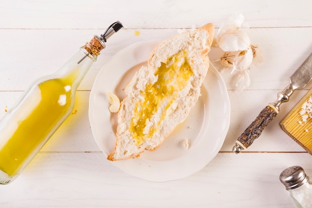 Plate of bread and oil on cooking desk