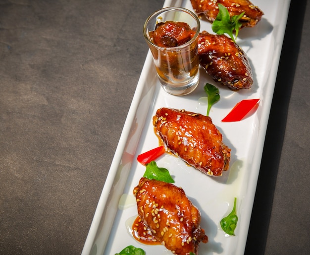 plate of chicken wings on Grunge black background