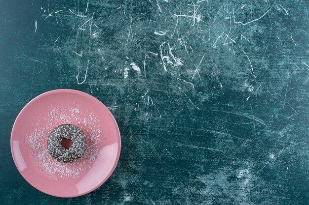 A plate of chocolate donut , on the blue background. High quality photo