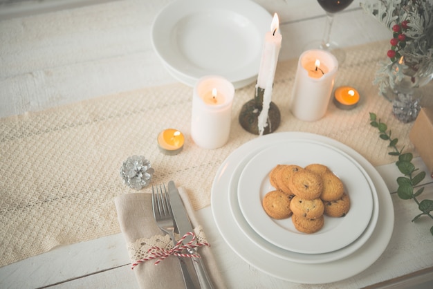 Plate of cookies on table set up for Christmas dinner