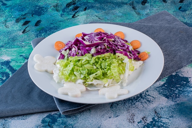 A plate of fresh various vegetables on a piece of fabric