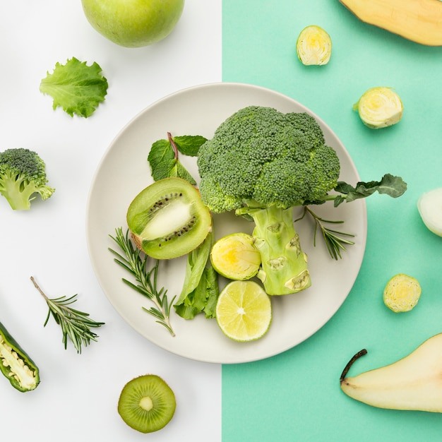 Plate full of green veggies and fruit