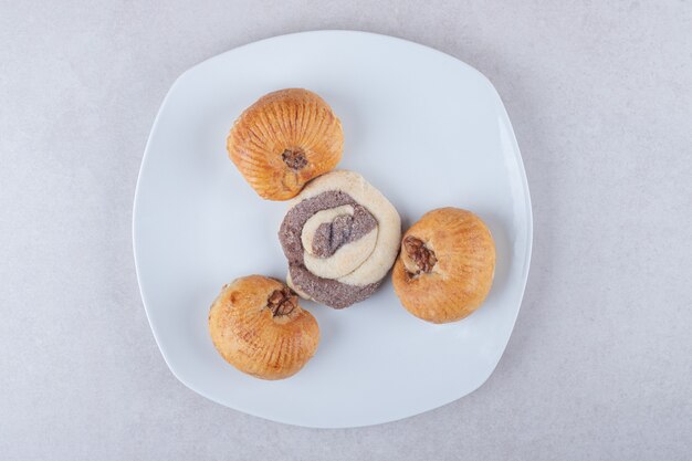 A plate of homemade sweet cookies on marble table.