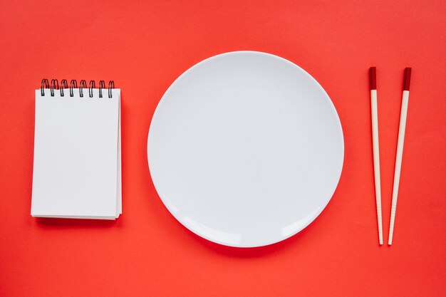 Plate between notebook and chopsticks