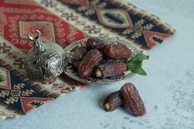Plate of organic dates on stone surface.