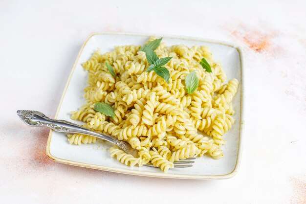 Plate of pasta with homemade pesto sauce.