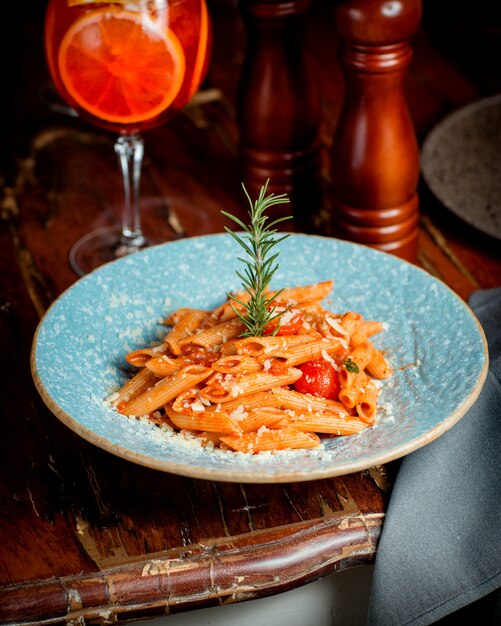 A plate of penne paste with tomato sauce and parmesan