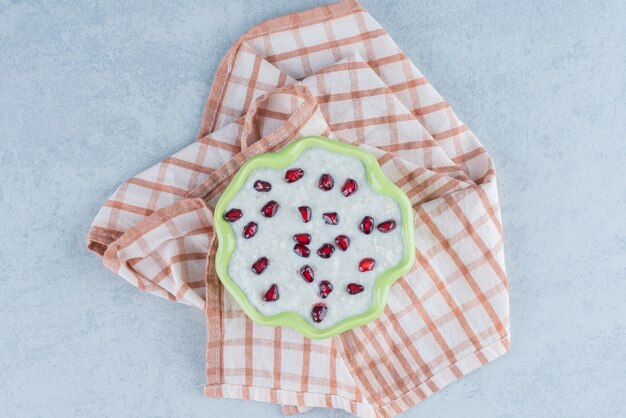 Free photo a plate of porridge on towel on marble.