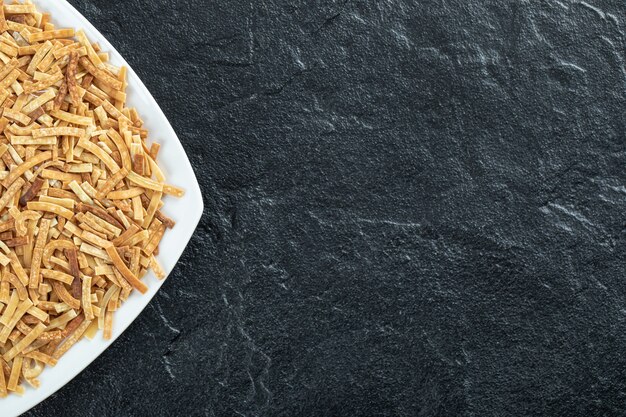 Plate of raw pasta on dark background. High quality photo