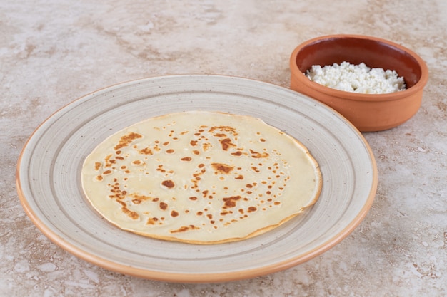 A plate of roll pancakes with cottage cheese