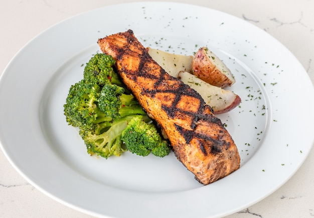 Plate of salmon steak with broccoli
