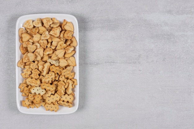 Plate of salted crackers on stone.