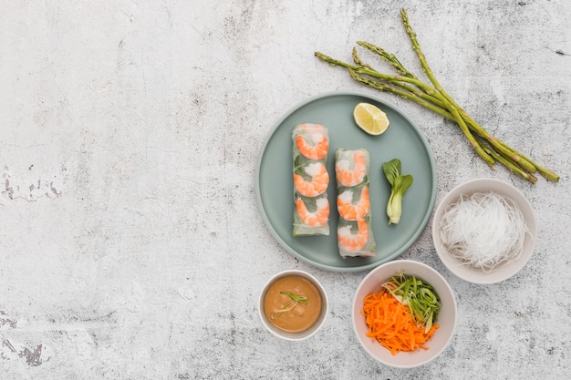 Plate of shrimp rolls with asparagus and copy space