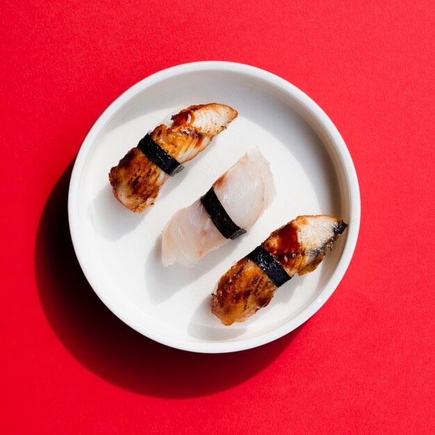 Plate of sushi on a red background