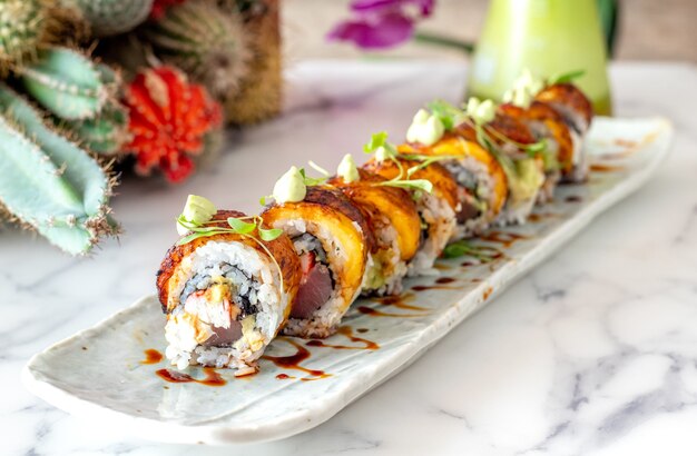 Plate of tasty crab and salmon sushi rolls