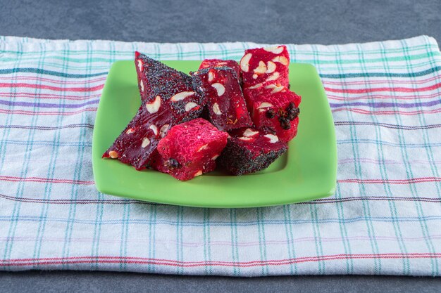 A plate of Turkish delights on a tea towel , on the marble background.