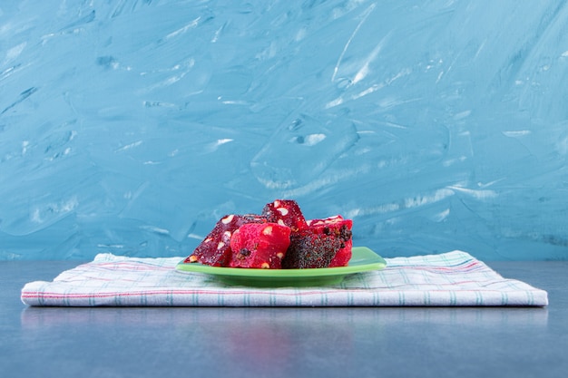 A plate of Turkish delights on a tea towel on the marble surface