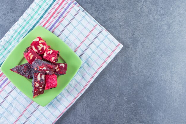 A plate of Turkish delights on a tea towel on the marble surface