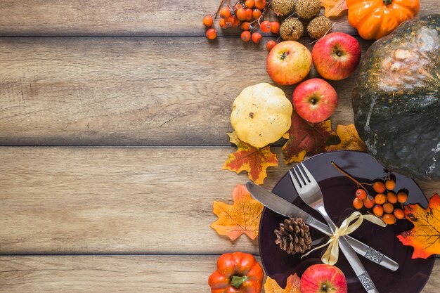 Plate between vegetables and dry leaves