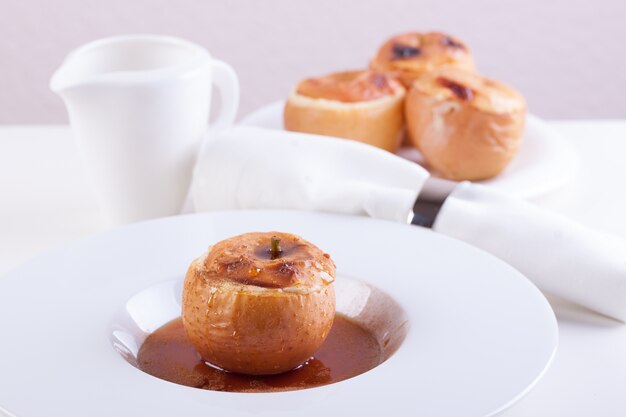 Plate with a baked apple with caramel