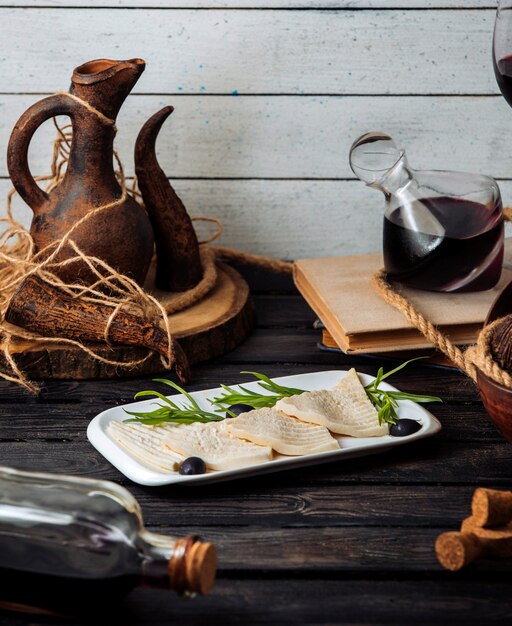 Plate with cheese on a wooden table