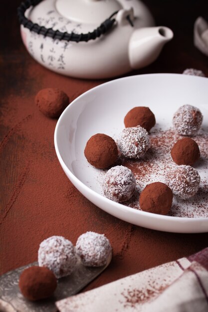 Plate with chocolates and teapot background