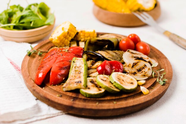 Plate with cooked on barbecue vegetables on table