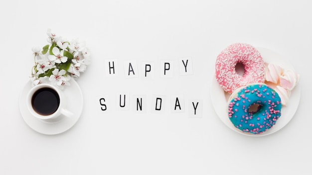 Plate with delicious doughnuts and flower