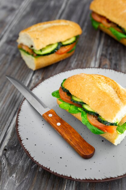 Plate with delicious sandwich and knife