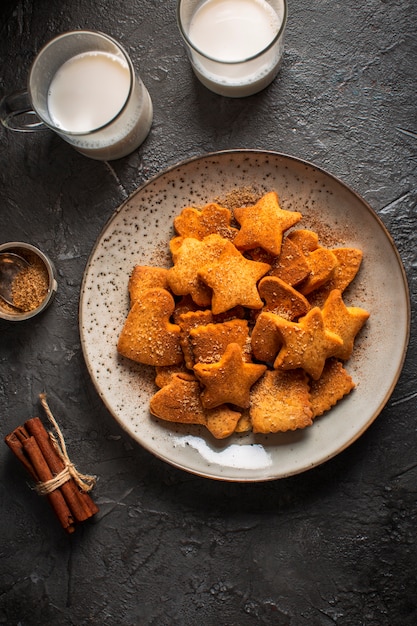 Free photo plate with different shaped biscuits and milk