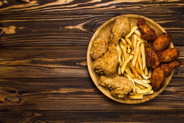 Plate with French fries and chicken