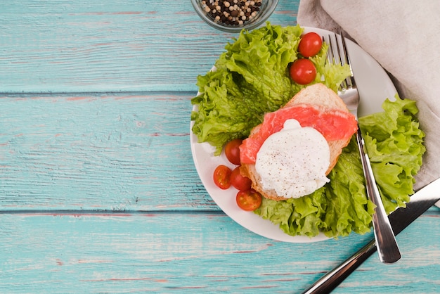 Plate with fresh sandwich on table