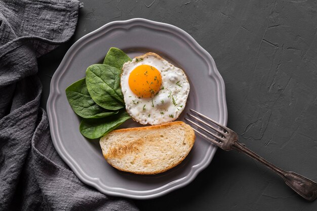 Plate with fried egg and bread