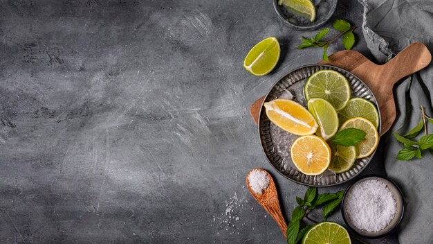 Plate with lime and lemon slices flat lay