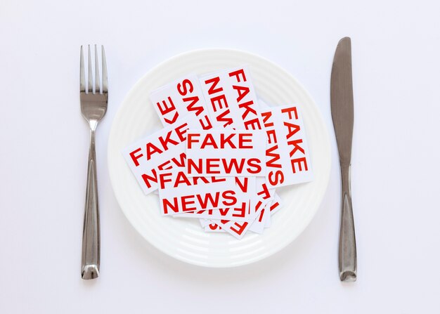 Plate with paper sheets with with fake news