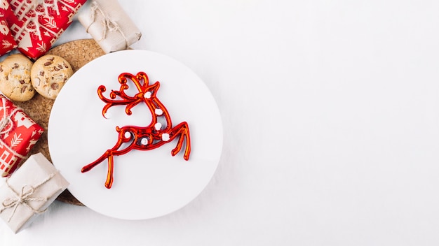 Plate with red deer on table 