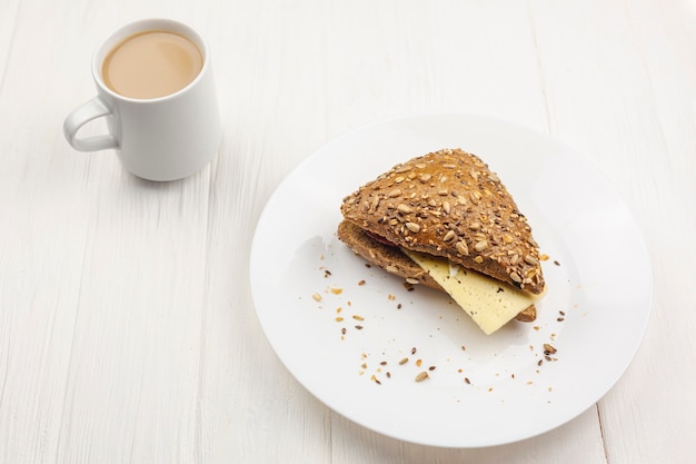 Plate with a sandwich and coffee cup