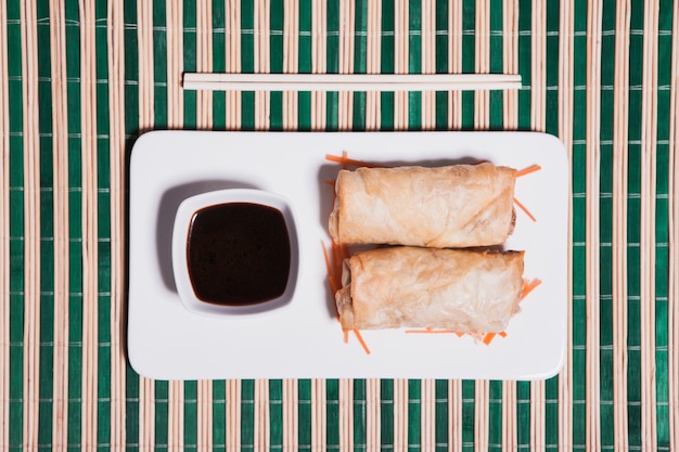 Plate with soy sauce and rolls