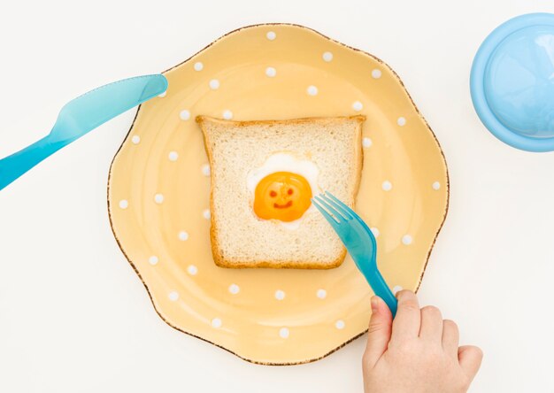 Plate with toast for baby on desk