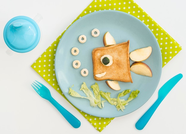 Plate with toast in fish shape with apple