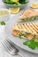 Free photo plate with triangular sandwiches and fork