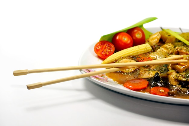 Plate with vegetables and chopsticks