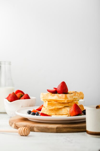 Plate with waffles stack with fruits