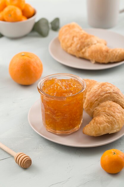 Plates with croissant and organic homemade marmalade