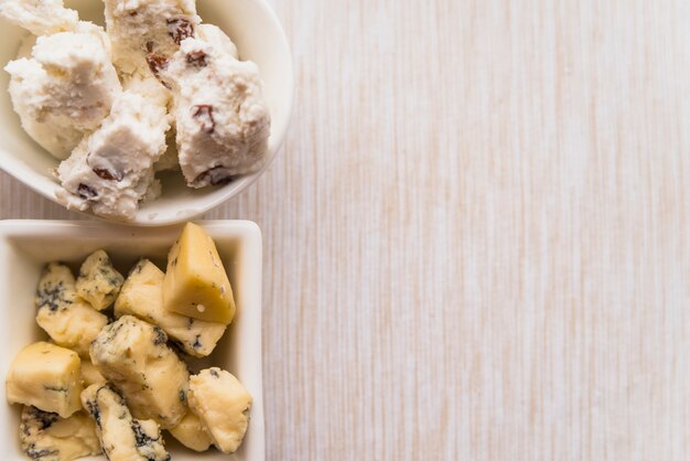 Plates with different fresh cheese on table