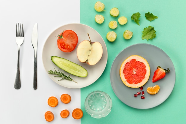 Plates with healthy food and cutlery