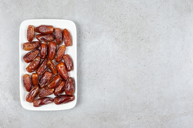 A platter of appetizing dates on marble background. High quality photo